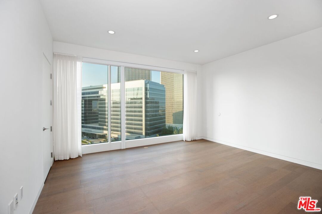 1 West Century Drive, Unit 8D Los Angeles, CA 90067 - Photo 8 of 12 an empty room with windows