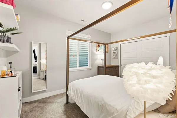 a bedroom with a large bed and a large window