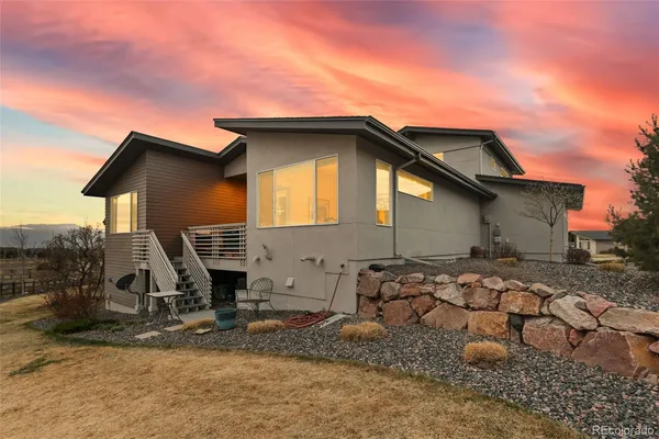 a view of a house with wooden fence