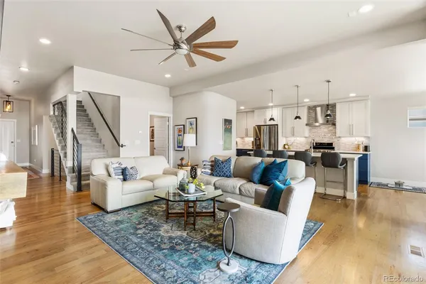 a living room with furniture and kitchen view