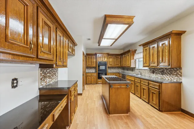 a kitchen with stainless steel appliances granite countertop a stove and a sink