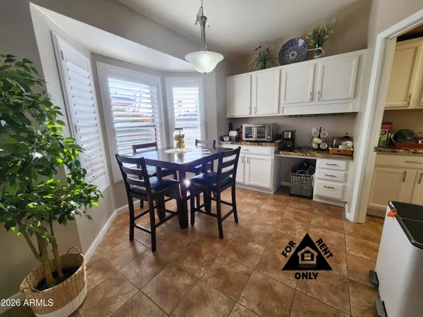 a view of a dining room with furniture and window