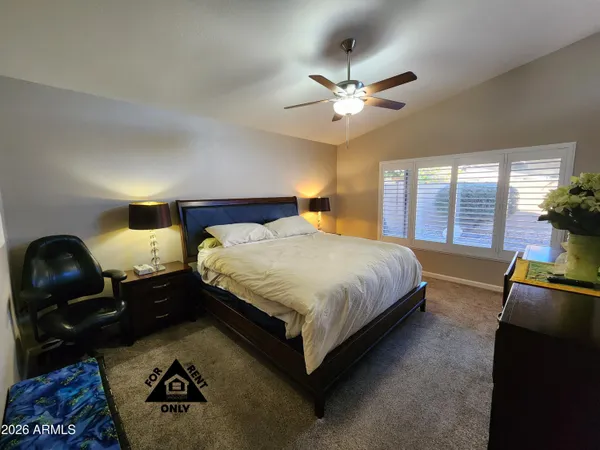 a bedroom with a bed and a dresser in it