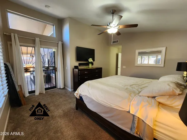 a bedroom with a bed and a chandelier