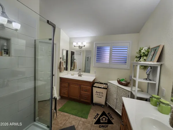 a bathroom with a sink double vanity and a mirror