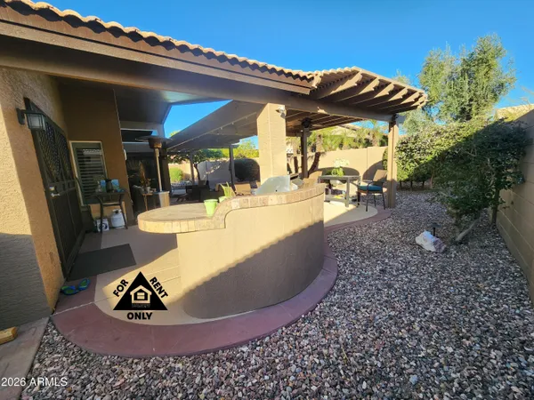 a view of a chairs and table in a backyard