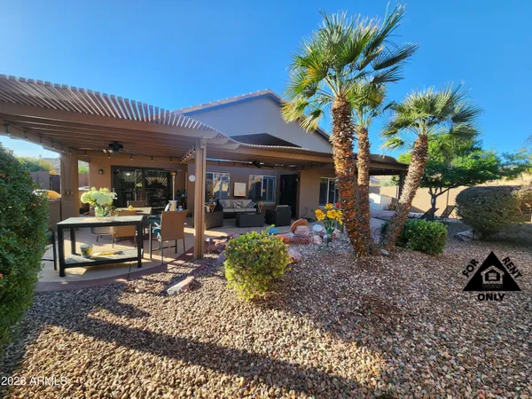 a backyard of a house with table and chairs