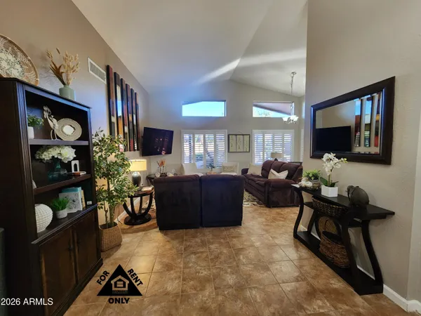 a living room with furniture a rug and a flat screen tv