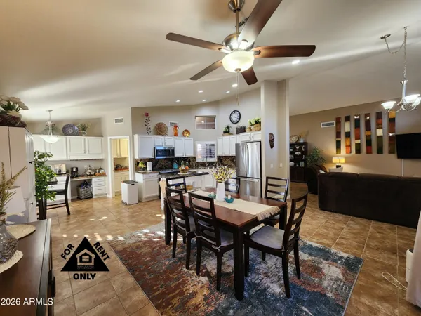 a living room with lots of furniture and kitchen view
