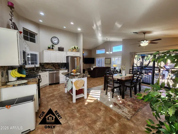 a open kitchen view with dining table and chairs
