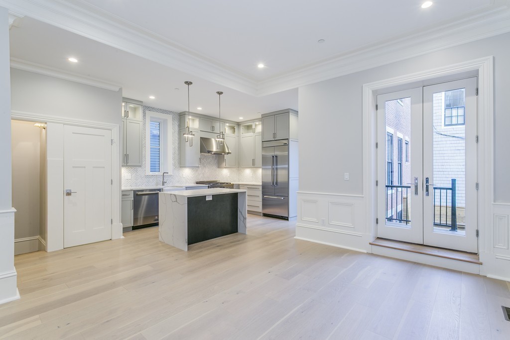 47 Chestnut Street, Unit 1 Boston, MA 02129 - Photo 4 of 17 a large kitchen with a large window and stainless steel appliances
