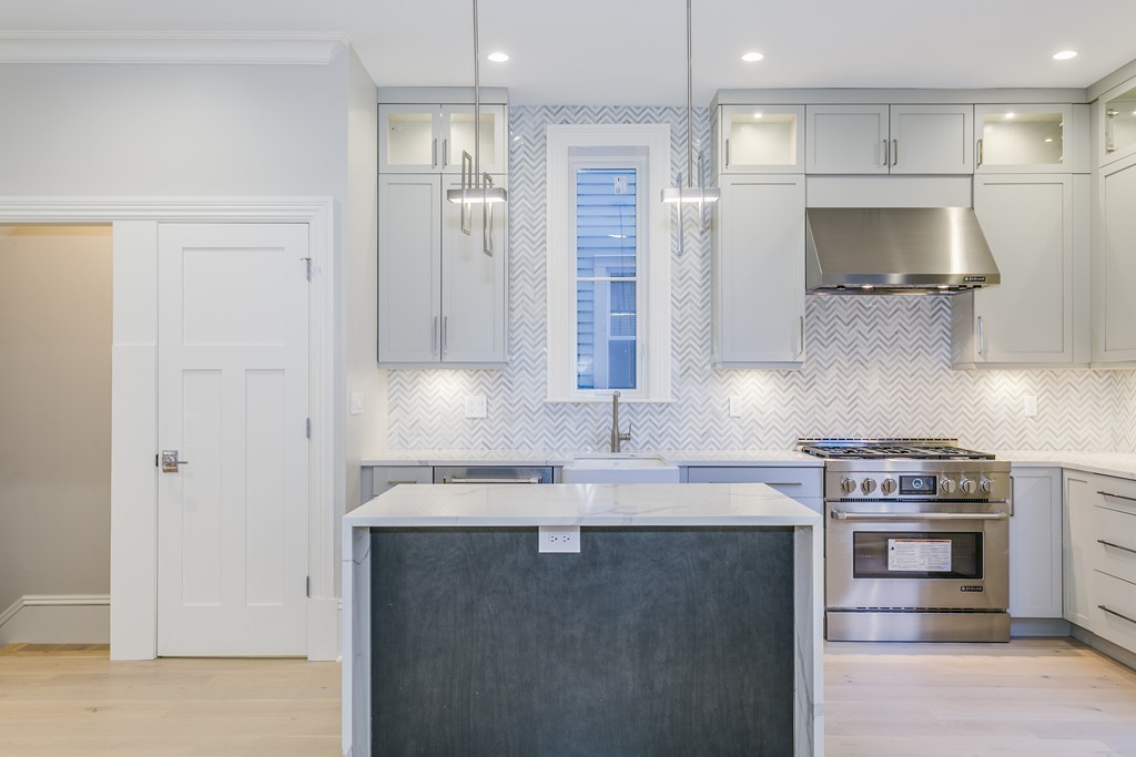 47 Chestnut Street, Unit 1 Boston, MA 02129 - Photo 8 of 17 a kitchen with stainless steel appliances granite countertop a sink a stove and a refrigerator