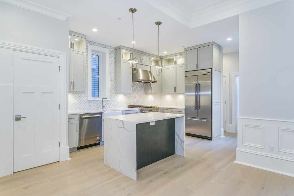 47 Chestnut Street, Unit 1 Boston, MA 02129 - Photo 9 of 17 a kitchen with stainless steel appliances granite countertop a sink and a refrigerator