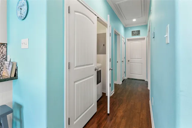 a view of a hallway with wooden floor