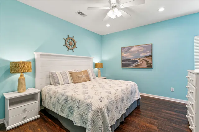 a bedroom with a bed and a painting on the wall