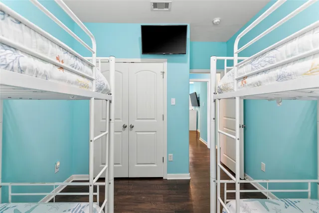 a view of a livingroom with wooden floor and stairs