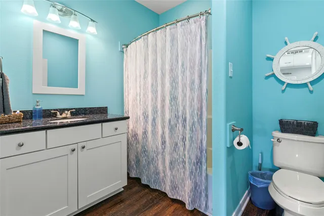 a bathroom with a toilet a sink and mirror