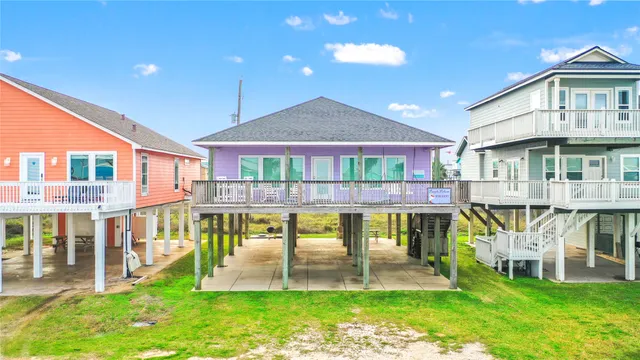a view of a house with a swimming pool and sitting area
