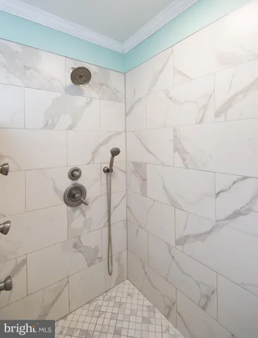 a bathroom with a double vanity sink a mirror and a shower