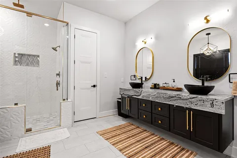 a spacious bathroom with a double vanity sink and a mirror