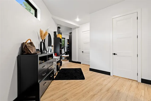 a view of a workspace with furniture and wooden floor