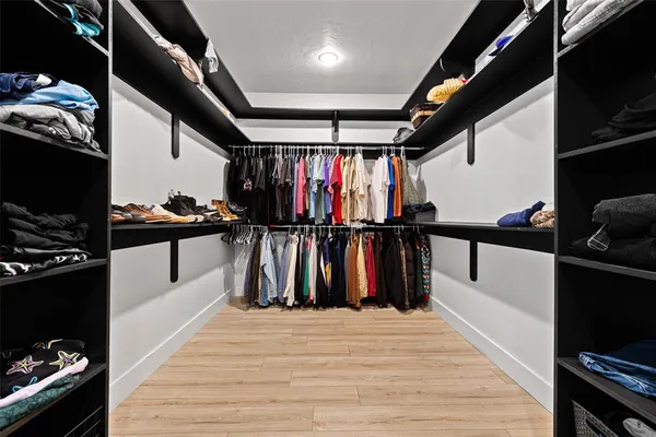 a hallway with a white stove and a wooden floor