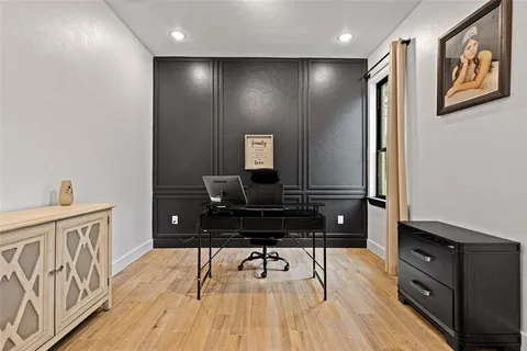 a view of a workspace with furniture and wooden floor