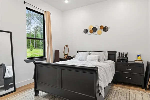 a bedroom with a bed and a window