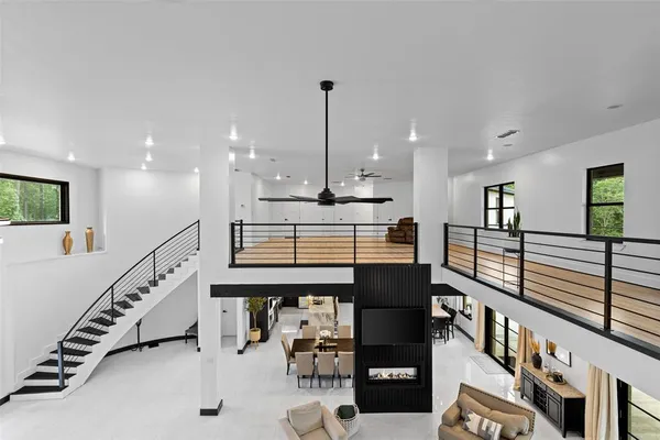 a kitchen with stainless steel appliances kitchen island granite countertop a stove a sink and a dining table with wooden floor