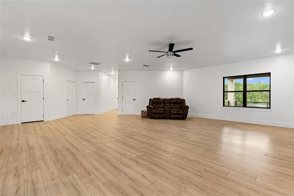 a view of a livingroom with a hardwood floor and a ceiling fan