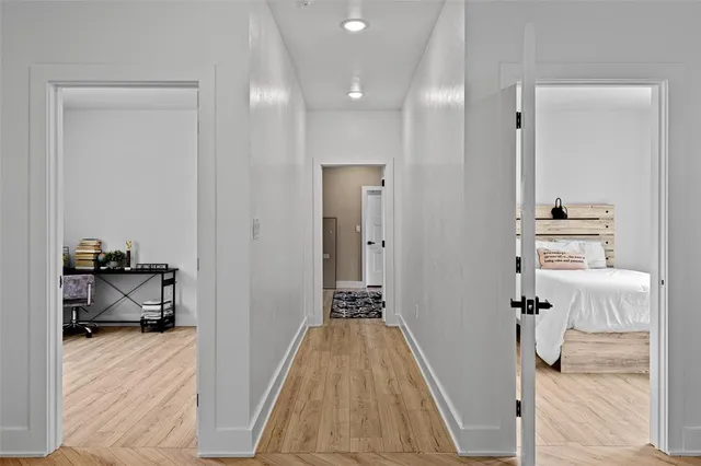 a bedroom with a bed a dresser next to a window