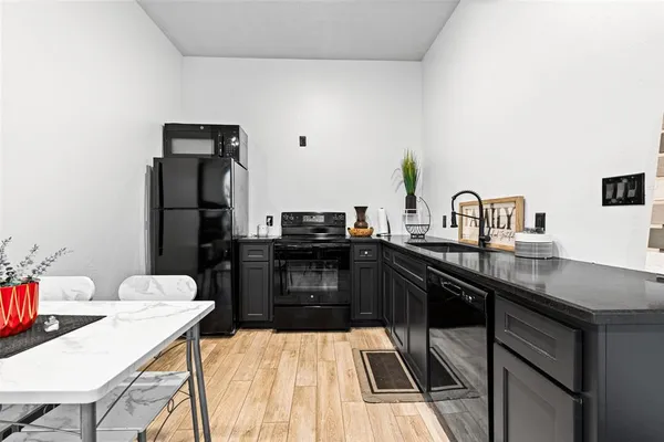 a kitchen with a sink a stove and chairs