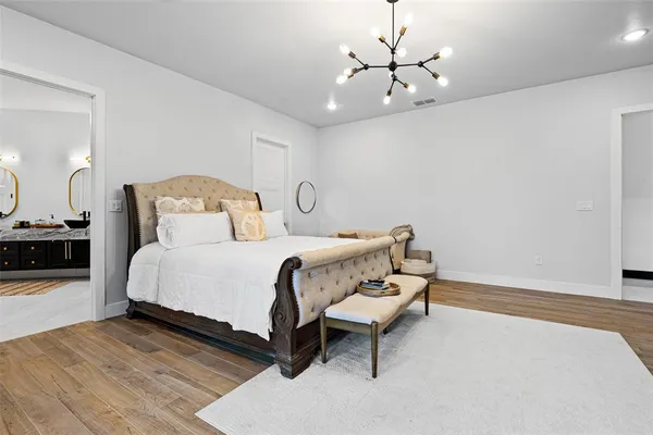 a bedroom with a bed and a chandelier