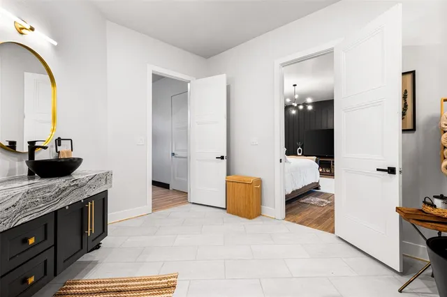 a walk in closet with wooden floor