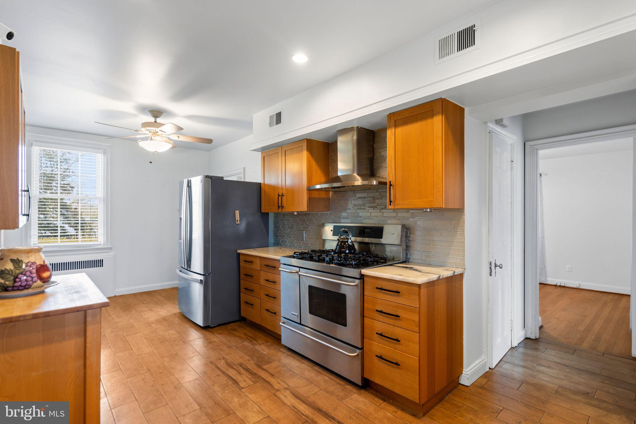 2116 Branch Avenue Southeast Washington, DC 20020 - Photo 16 of 32 a kitchen with stainless steel appliances granite countertop a refrigerator a stove a sink and a microwave