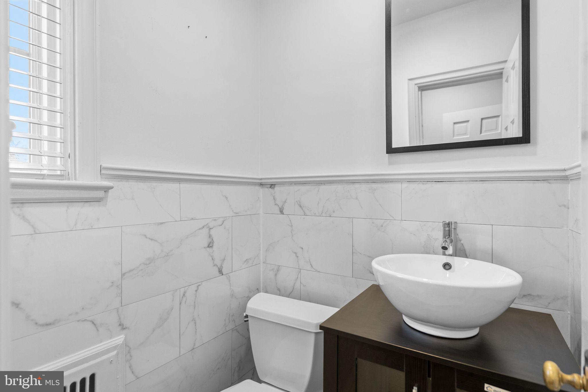 2116 Branch Avenue Southeast Washington, DC 20020 - Photo 17 of 32 a bathroom with a sink a toilet and a mirror