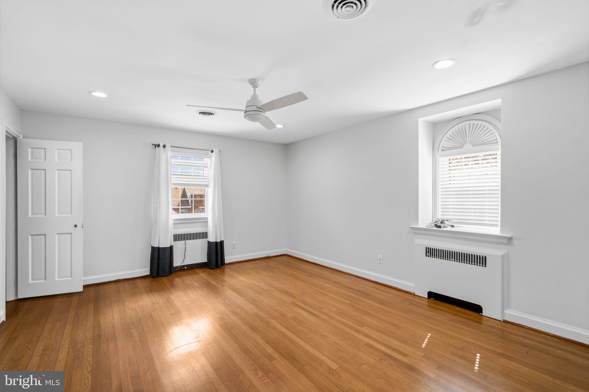 2116 Branch Avenue Southeast Washington, DC 20020 - Photo 24 of 32 an empty room with wooden floor cabinet and windows