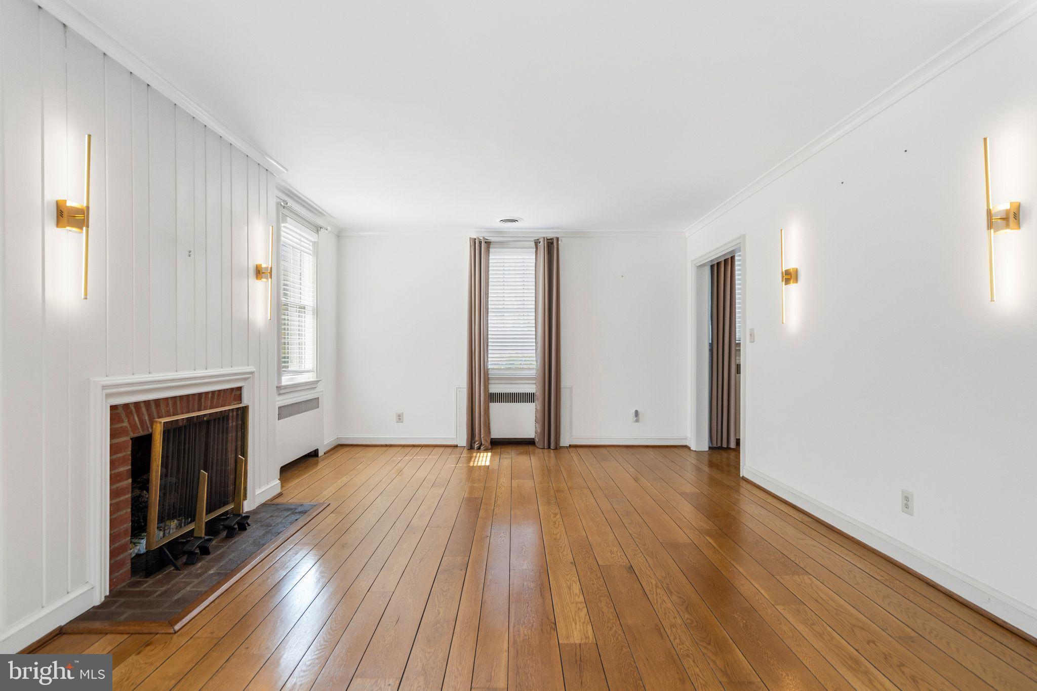 2116 Branch Avenue Southeast Washington, DC 20020 - Photo 6 of 32 an empty room with wooden floor fireplace and windows