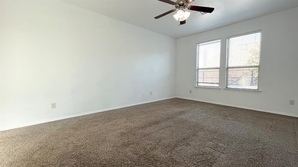 101 Rocky Pine Road McKinney, TX 75072 - Photo 11 of 31 an empty room with a window and a ceiling fan