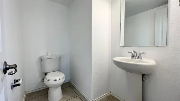 a bathroom with a sink toilet and a mirror