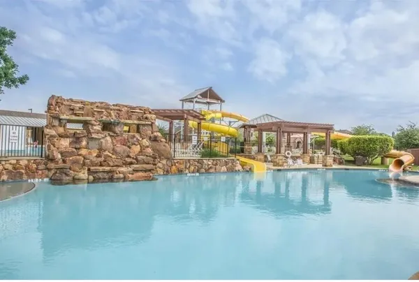 a view of swimming pool with outdoor seating and lake view