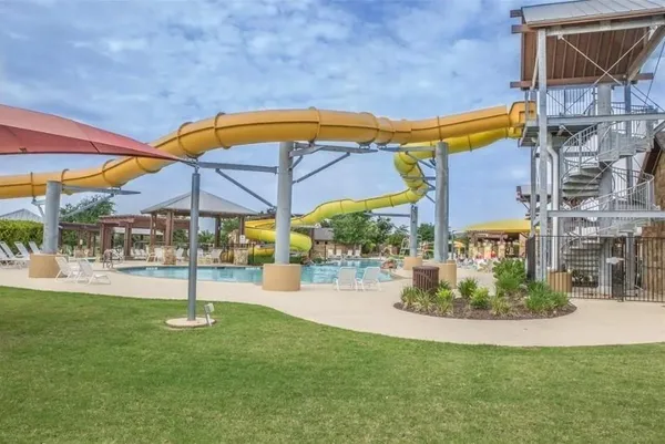 a view of pool with a table and chairs