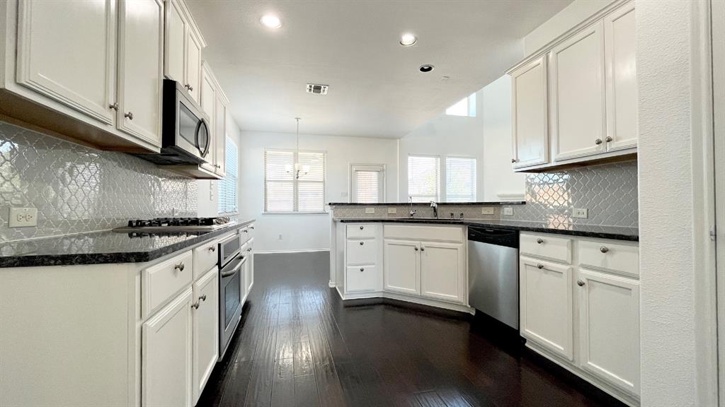 101 Rocky Pine Road McKinney, TX 75072 - Photo 3 of 31 a kitchen with granite countertop white cabinets and white appliances