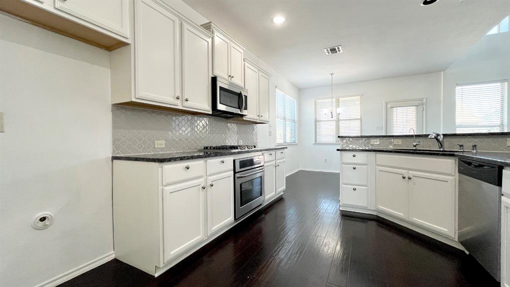 101 Rocky Pine Road McKinney, TX 75072 - Photo 4 of 31 a kitchen with granite countertop white cabinets and white appliances