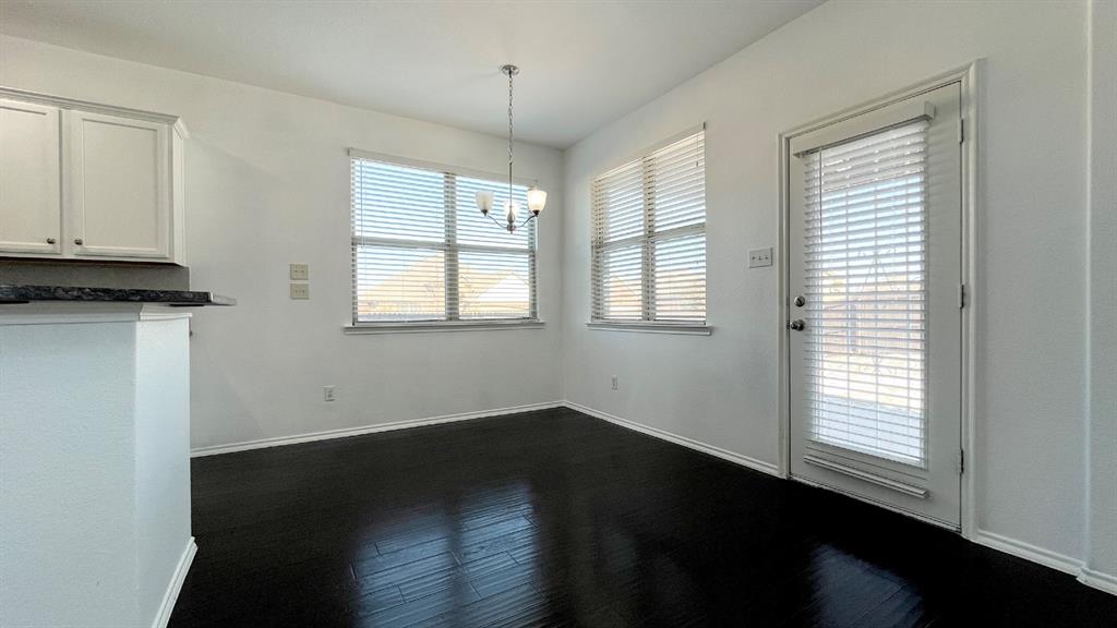 101 Rocky Pine Road McKinney, TX 75072 - Photo 5 of 31 an empty room with wooden floor and windows