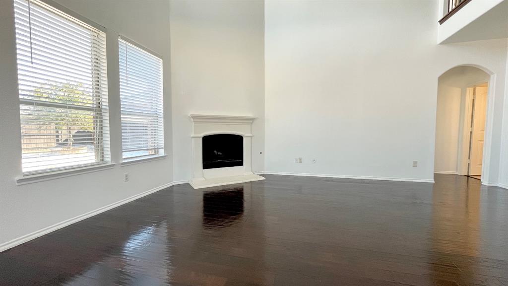 101 Rocky Pine Road McKinney, TX 75072 - Photo 8 of 31 a view of empty room with wooden floor and fireplace