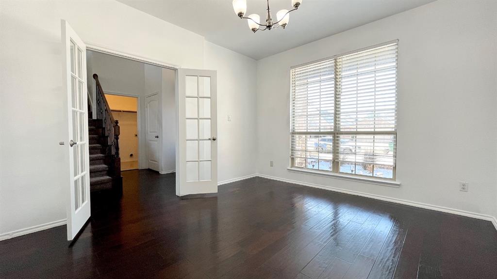 101 Rocky Pine Road McKinney, TX 75072 - Photo 9 of 31 a view of an empty room with wooden floor and a window