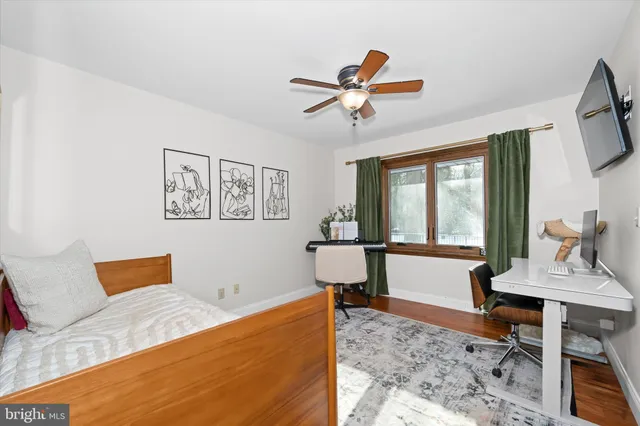 a bed room with a bed a couch and a window