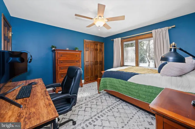 a bedroom with a bed chair and window