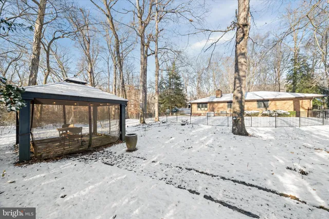 a view of a yard with snow on the road